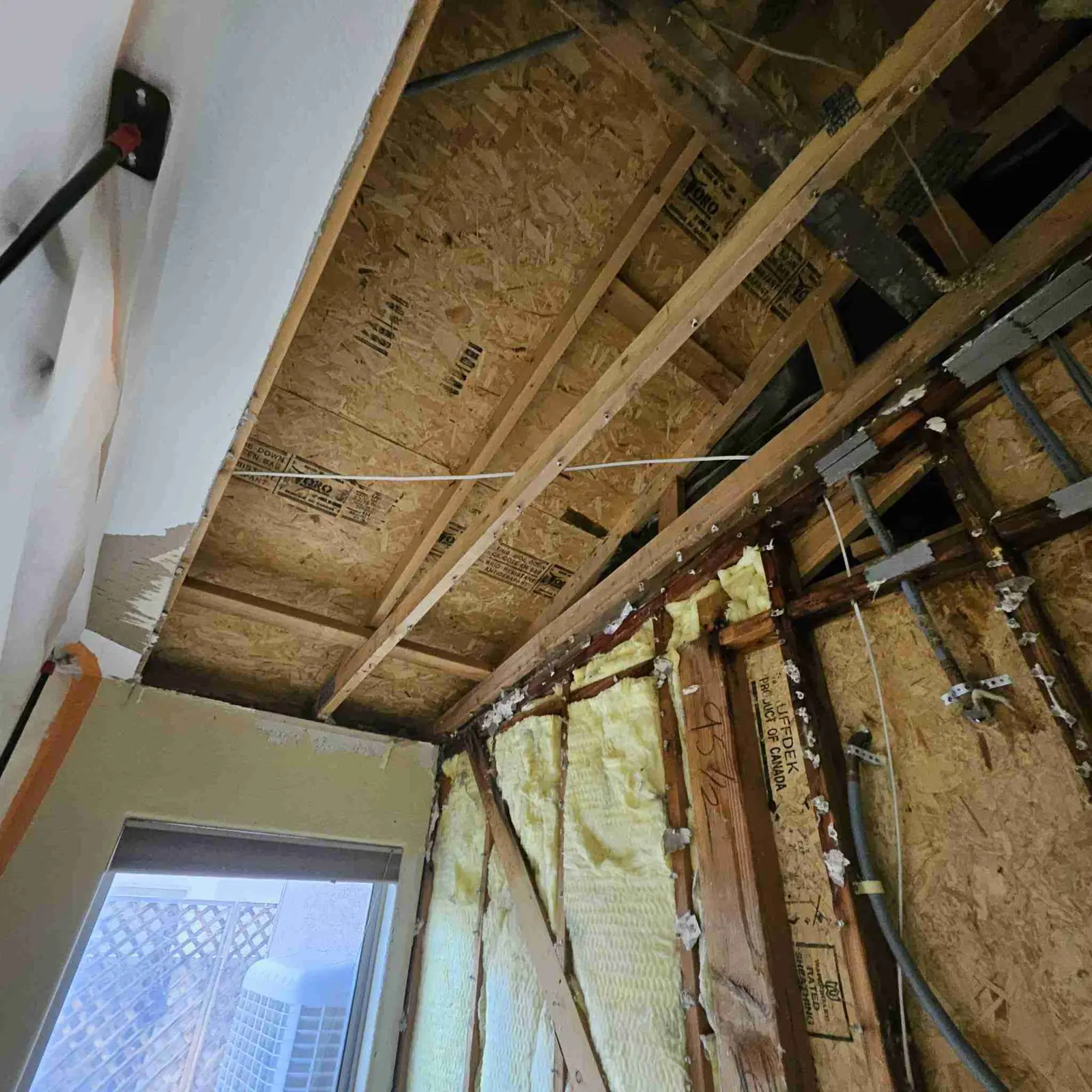 Ceiling opened to expose wet joists so they can dry