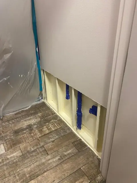 Plastic containment and a flood-cut wall during drying