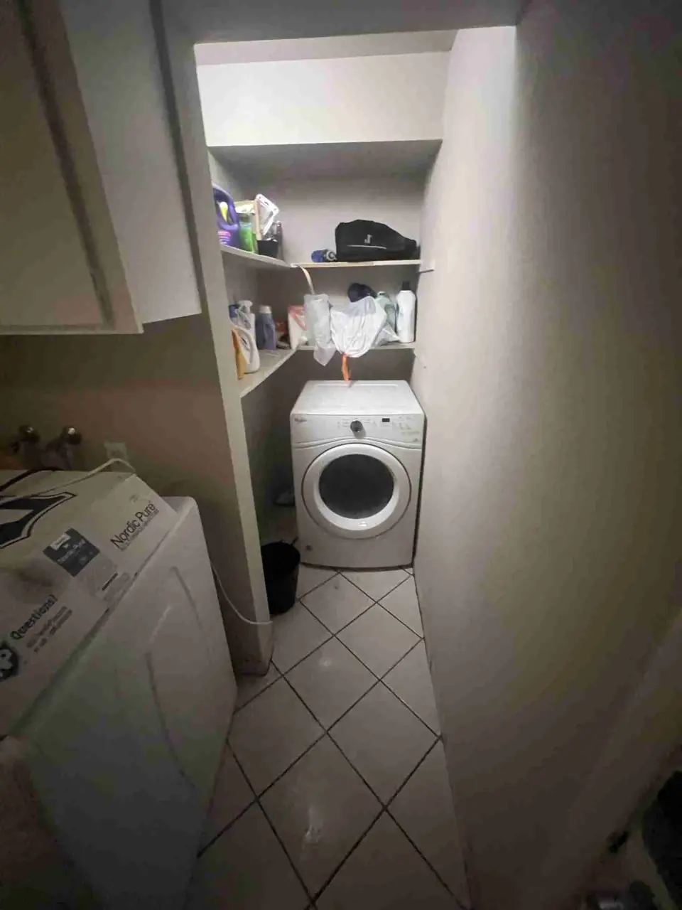 Standing water on a laundry room tile floor