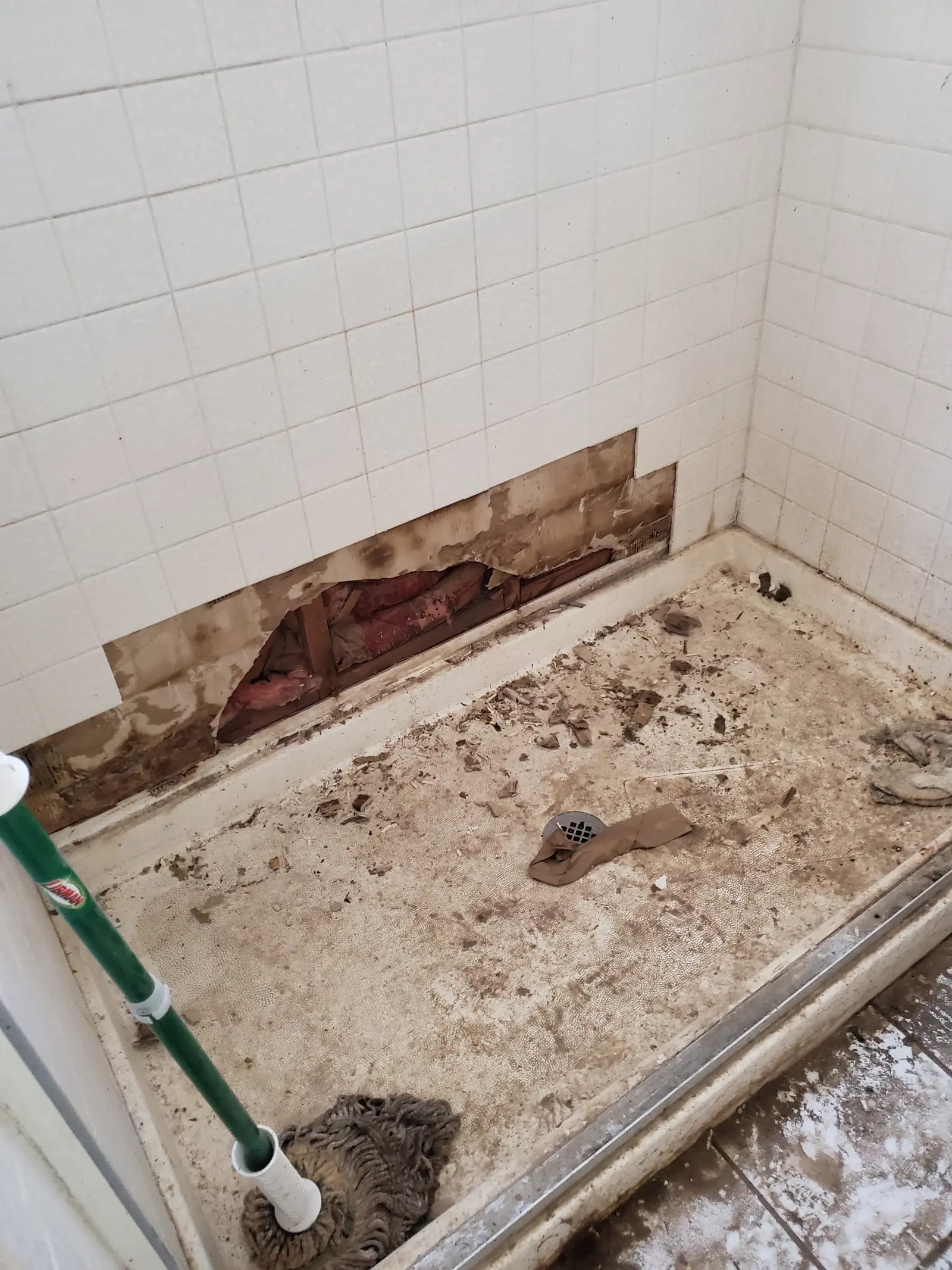 Shower pan torn out to reach a leak underneath