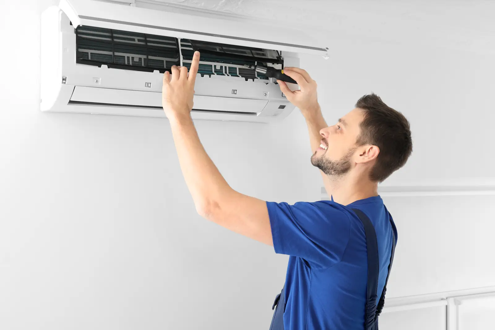 Technician servicing an air conditioning unit
