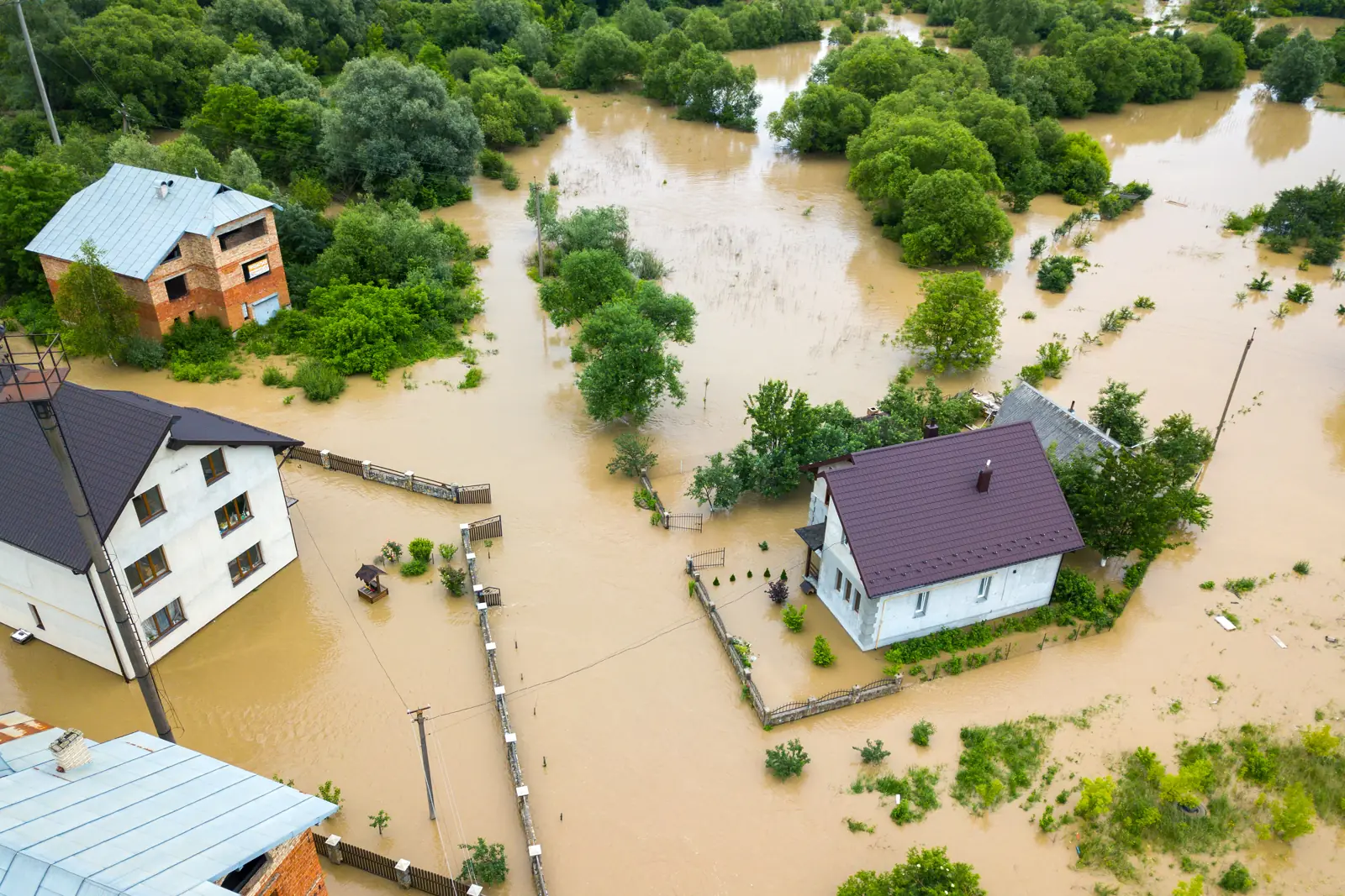Aerial view of homes surrounded by flood water